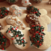 Mickey-shaped sugar cookies partially dipped in semi-sweet or white chocolate with red, green, silver, and gold sprinkles, arranged on a white plate for a cheerful Christmas in July treat.