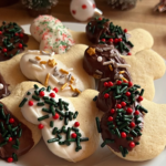 Mickey-shaped sugar cookies partially dipped in semi-sweet or white chocolate with red, green, silver, and gold sprinkles, arranged on a white plate for a cheerful Christmas in July treat.