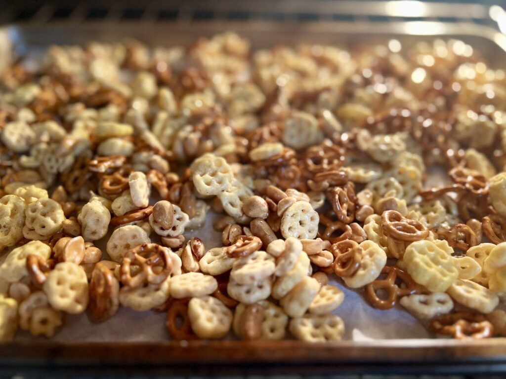 Sweet & salty Honey Cereal Snack Mix bakes in the soft glow of the oven.
