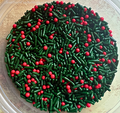 Festive red and green sprinkles waiting to be added to cookie dough.