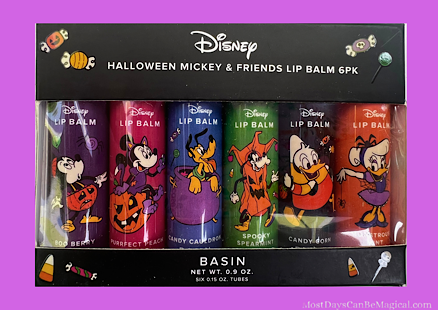 Six colorful Disney-inspired Halloween lip balms are arranged neatly in a seasonal box. Each lip balm features a unique flavor and color with nods to different characters, perfect for fans of whimsical skin care.