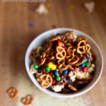 A Sweet and Salty Popcorn Bowl consisting of layers of caramel corn, chocolate drizzle, mimi M&Ms and mini pretzels.