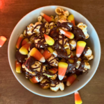 This Disney-inspired Candy Corn Popcorn bowl layered with caramel corn, candy corn, and chocolate drizzle, is the perfect Halloween movie night snack!
