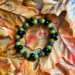 How to make a DIY Disney-inspired purple, Green & black Halloween stretch bracelet featuring Mickey-shaped focal beads.