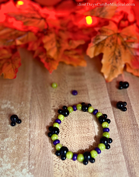 How to make a DIY Disney-inspired purple, Green & black Halloween stretch bracelet  featuring Mickey-shaped focal beads. 