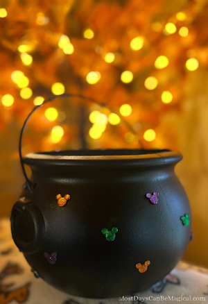 This DIY Disney-inspired Halloween cauldron is covered in Mickey-shaped festive rhinestones.