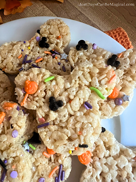 A close-up of Disney-inspired Mickey-shaped Rice Krispies Treats with Halloween sprinkles.