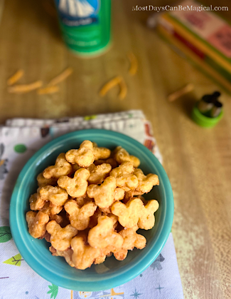 A small blue bowl of Mickey-shaped cheese crackers are the perfect Disney-inspired savory treat.