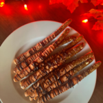 Disney-inspired Tigger-Tail themed Pretzel rods are the perfect Autumn colors for your Halloween party.