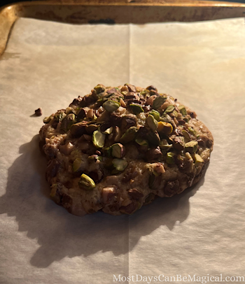 A Colossal Pistachio Toffee Cookie is almost finished baking in the oven.