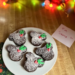 A white plate of Disney-inspired brownies with Mickey-shaped holly berries with leaves.