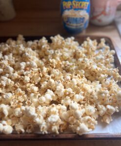 Homemade Sweet & Salty Maple Popcorn on a cookie sheet that just came out of the oven.